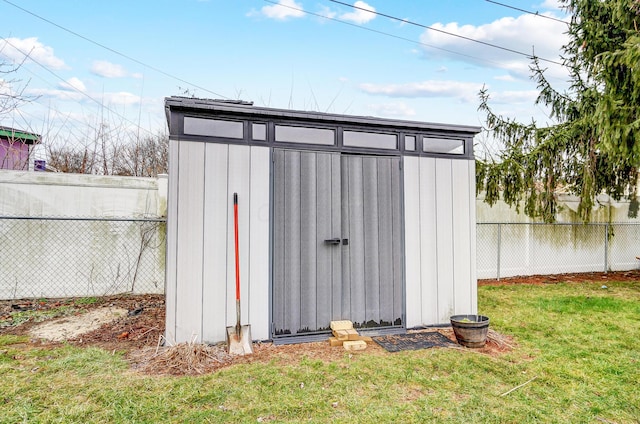 view of outbuilding with a yard