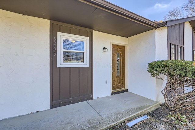 doorway to property featuring board and batten siding