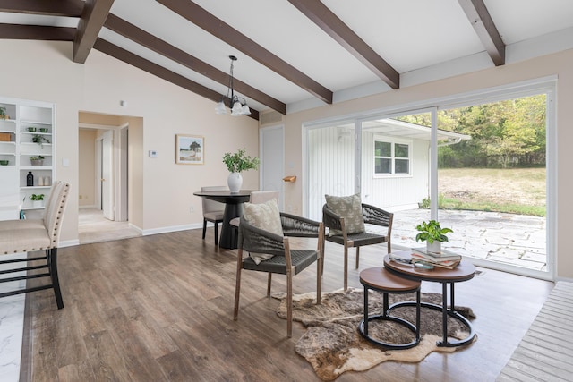 living room with hardwood / wood-style flooring, high vaulted ceiling, an inviting chandelier, and beamed ceiling