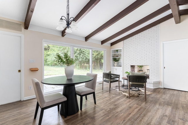 dining room with wood-type flooring, a chandelier, and vaulted ceiling with beams