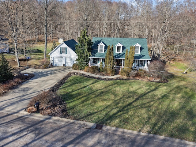 cape cod home featuring a garage, a front yard, and a porch