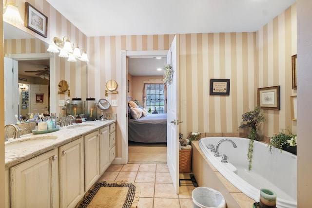 bathroom featuring vanity, a washtub, tile patterned floors, and ceiling fan