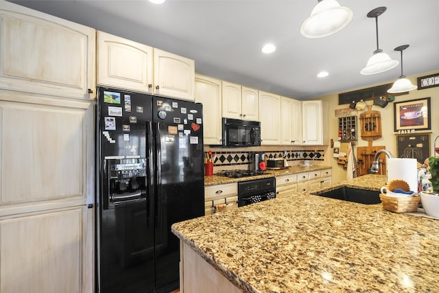 kitchen with sink, decorative light fixtures, black appliances, and light stone countertops