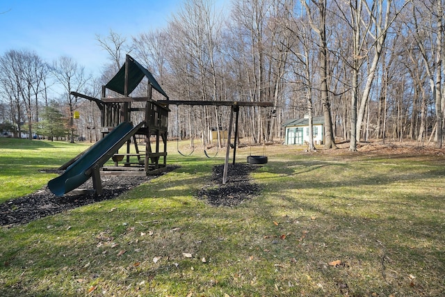 view of playground with a shed and a lawn