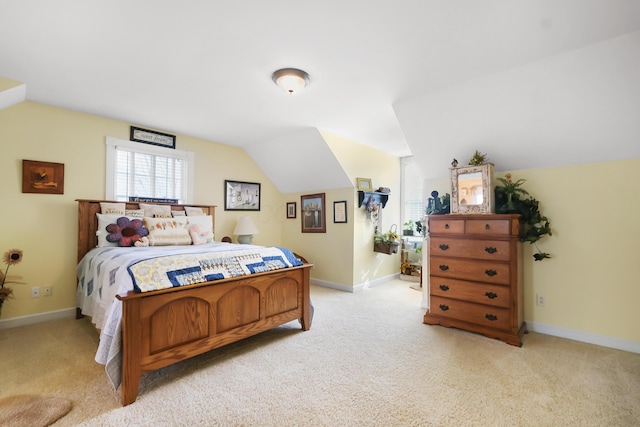bedroom featuring lofted ceiling and light carpet
