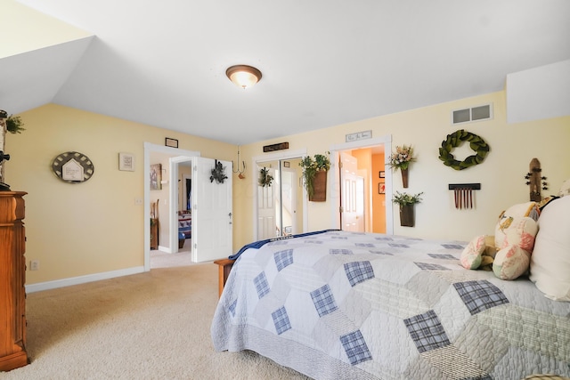 carpeted bedroom with lofted ceiling and a closet