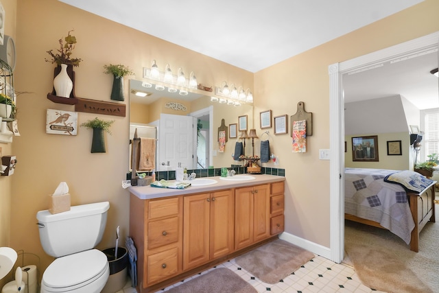bathroom featuring vanity, toilet, and a shower with shower door