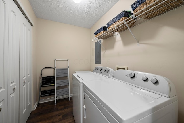 laundry area with dark wood-type flooring, independent washer and dryer, electric panel, a textured ceiling, and laundry area