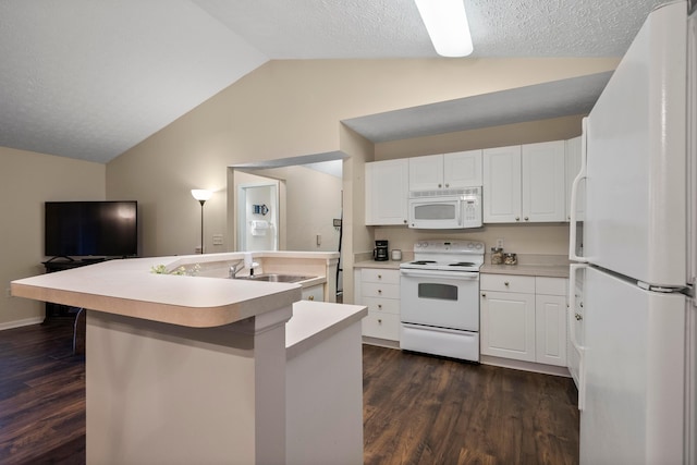 kitchen featuring white appliances, dark wood-type flooring, lofted ceiling, and a center island with sink