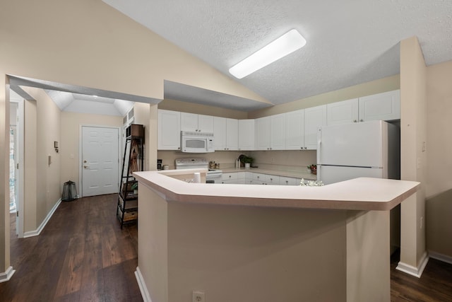 kitchen with white appliances, white cabinets, light countertops, lofted ceiling, and dark wood-style flooring