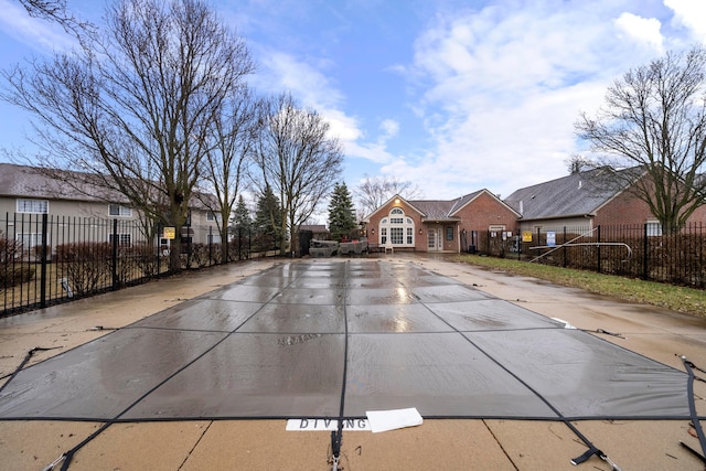 view of swimming pool with a fenced front yard