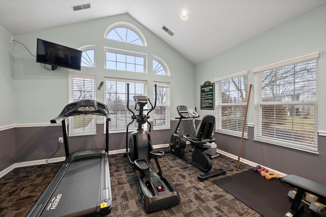 workout area featuring carpet flooring, baseboards, visible vents, and high vaulted ceiling