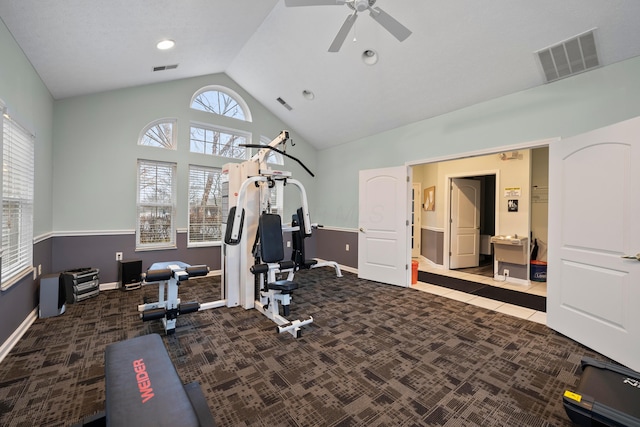 exercise room with vaulted ceiling, carpet, visible vents, and baseboards