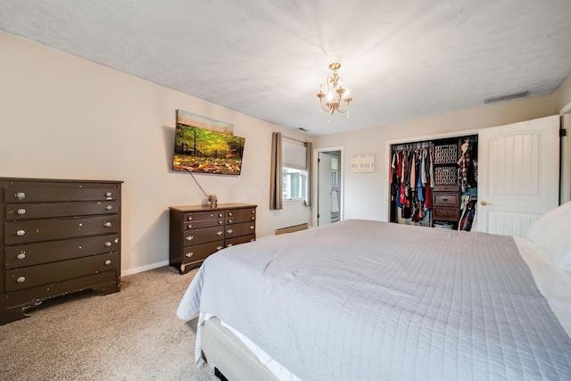 carpeted bedroom featuring a closet and a notable chandelier