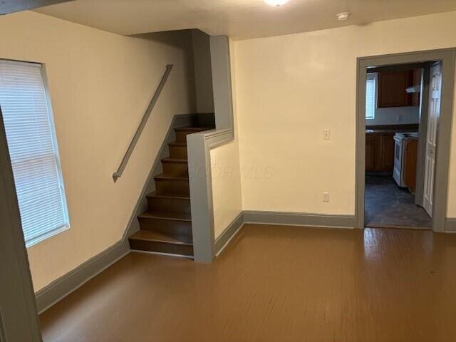 staircase with wood finished floors and baseboards