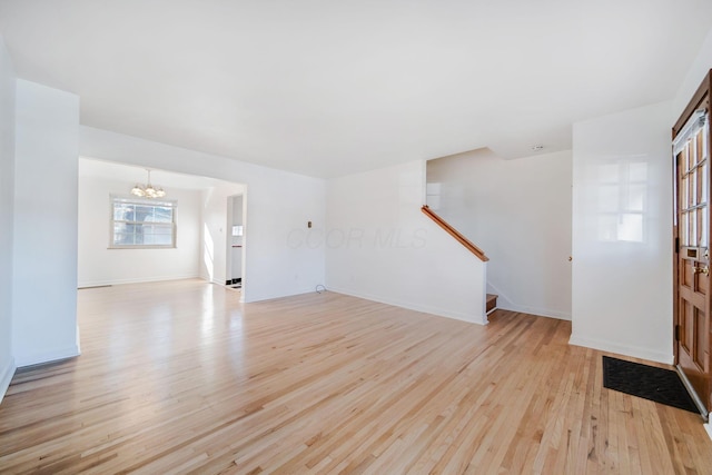 entryway with an inviting chandelier and light wood-type flooring