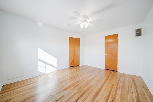 spare room featuring light hardwood / wood-style flooring and ceiling fan