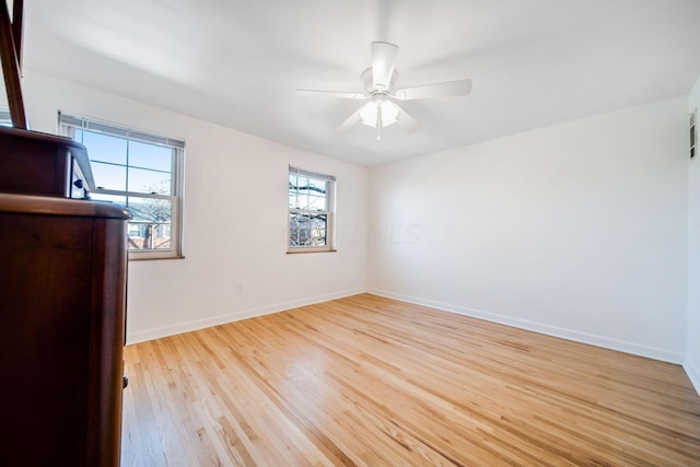 spare room with light hardwood / wood-style flooring and ceiling fan