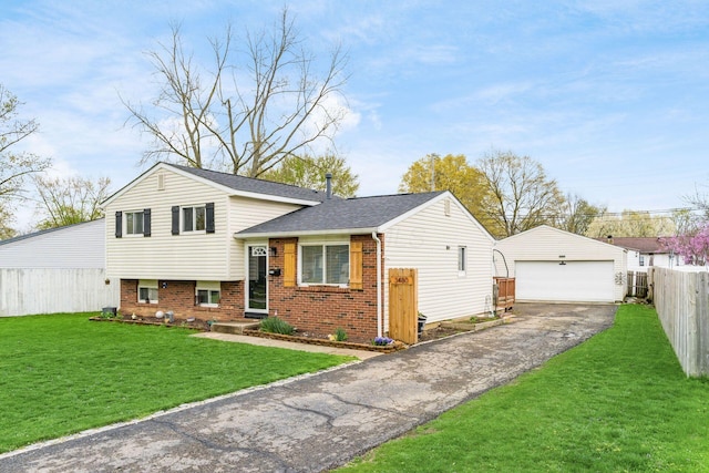 split level home featuring an outdoor structure, brick siding, fence, a detached garage, and a front lawn