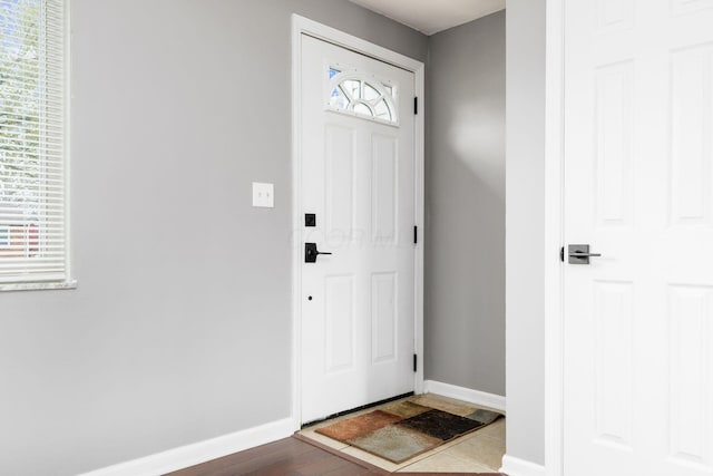 entryway featuring baseboards and wood finished floors