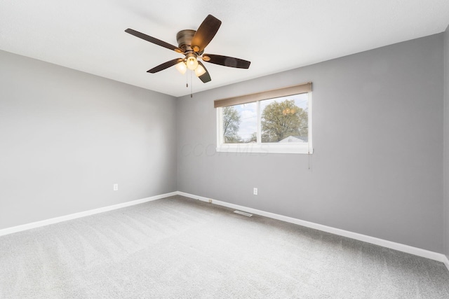 spare room featuring baseboards, ceiling fan, and carpet flooring