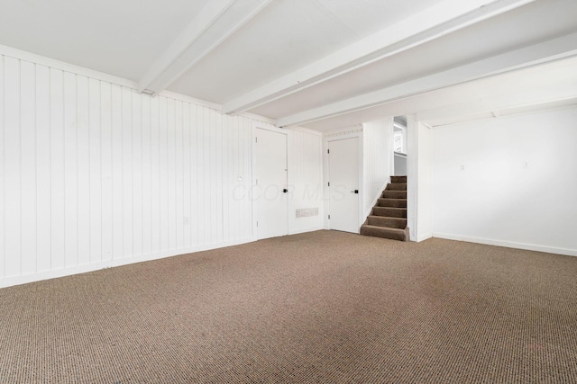 unfurnished room featuring stairs, beam ceiling, and carpet floors