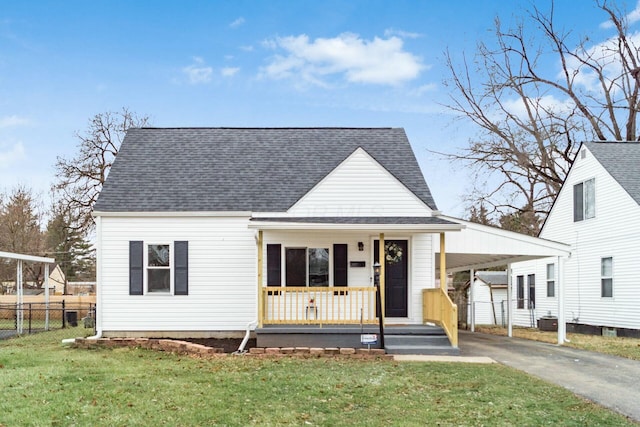 view of front of home featuring a carport, a front yard, and covered porch