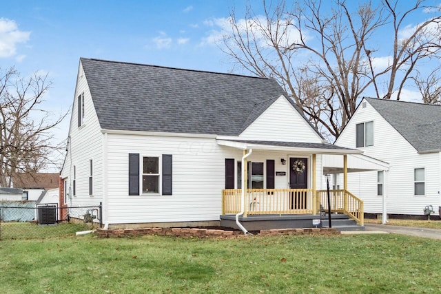 view of front facade featuring central AC, a front yard, and covered porch