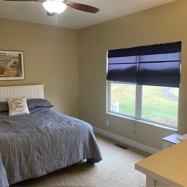 bedroom with ceiling fan, carpet flooring, visible vents, and baseboards