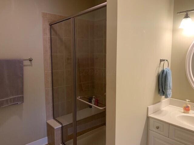 full bath featuring a stall shower and vanity