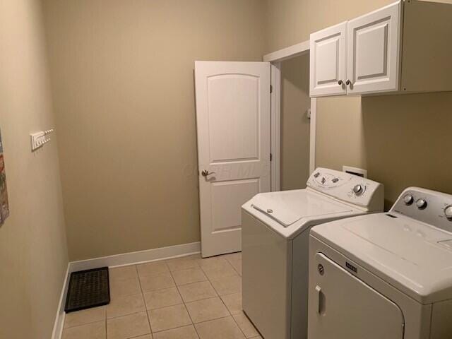 washroom with cabinet space, visible vents, washing machine and dryer, light tile patterned flooring, and baseboards