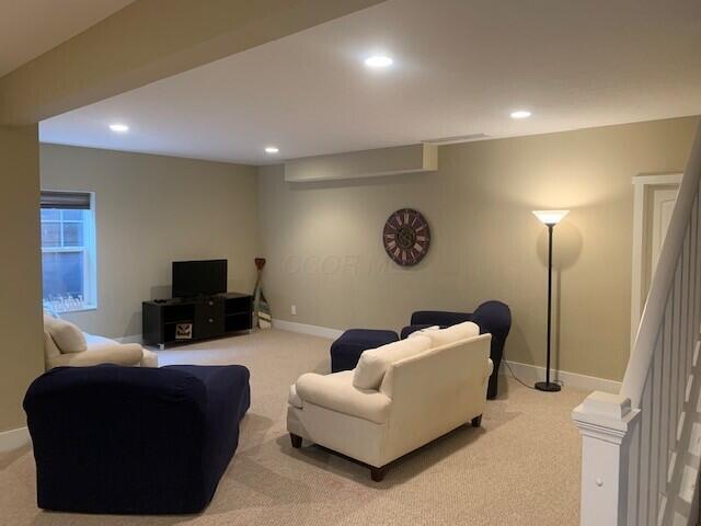 living room featuring recessed lighting, carpet flooring, and baseboards