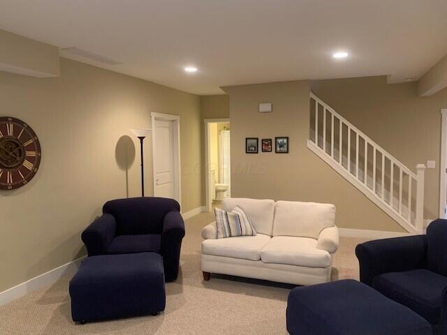 carpeted living area featuring stairs, recessed lighting, and baseboards