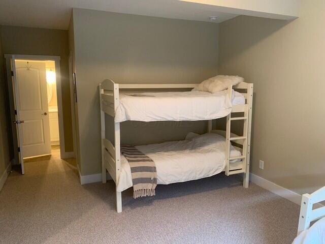 bedroom with carpet flooring and baseboards