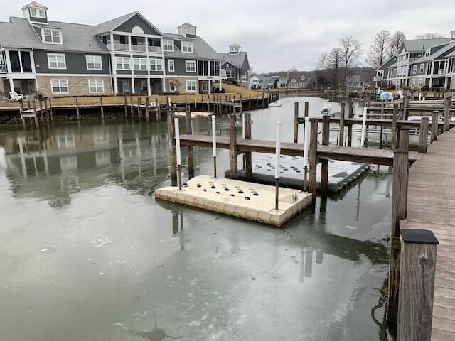 dock area with a residential view and a water view