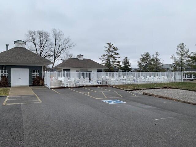 uncovered parking lot featuring fence