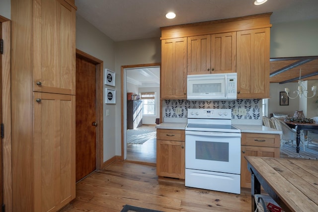 kitchen featuring backsplash, white appliances, and light hardwood / wood-style floors