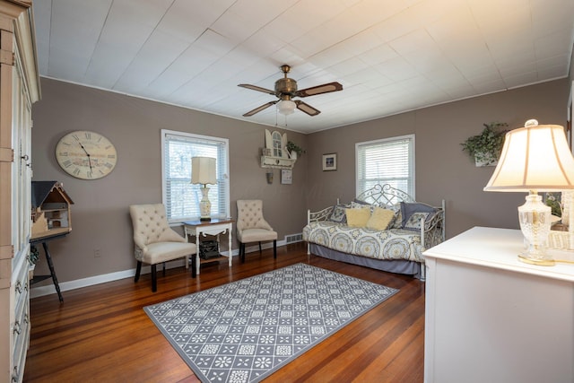 living room with ceiling fan and dark hardwood / wood-style floors