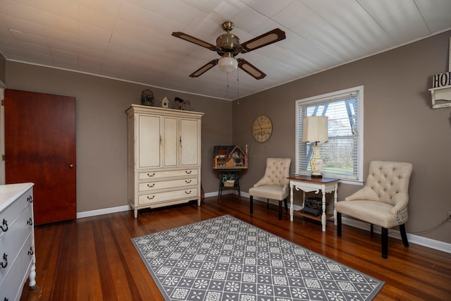 living area featuring ceiling fan and dark hardwood / wood-style flooring