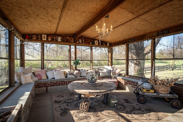 sunroom / solarium with vaulted ceiling and a notable chandelier