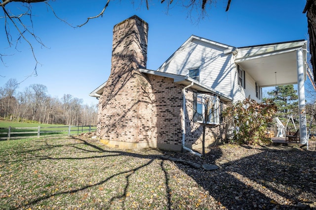 view of home's exterior with a yard