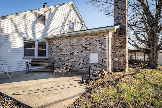 rear view of property featuring a patio area