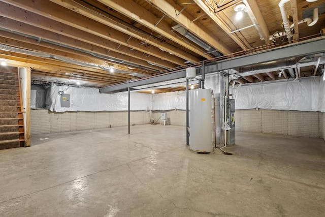 basement with electric panel, heating unit, and gas water heater