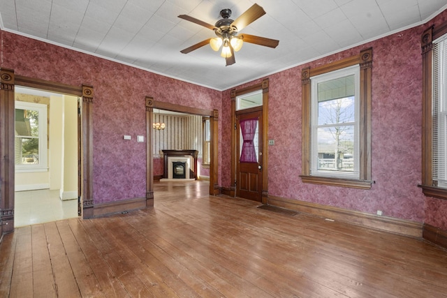 foyer featuring ceiling fan, ornamental molding, and hardwood / wood-style floors