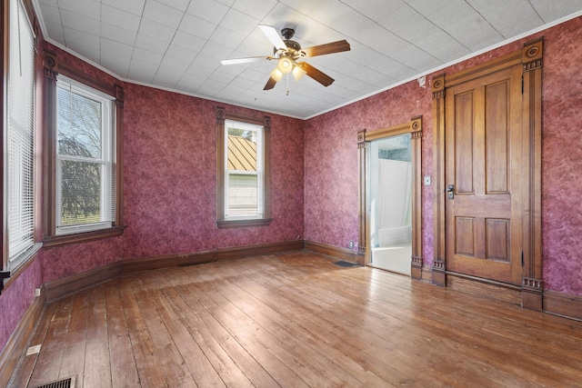 unfurnished room featuring hardwood / wood-style flooring, ceiling fan, and crown molding