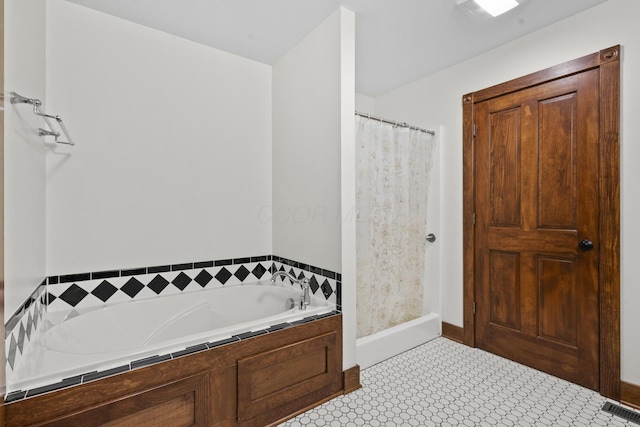 bathroom featuring tiled bath