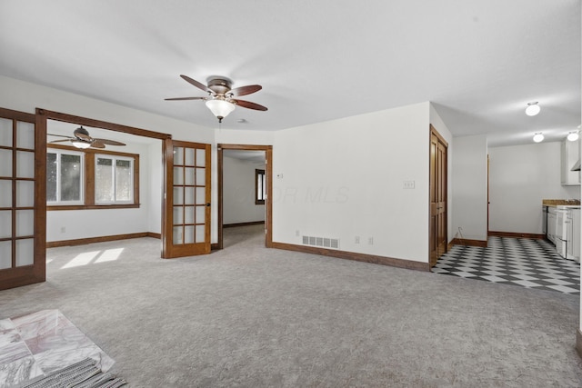 unfurnished living room with light carpet and french doors