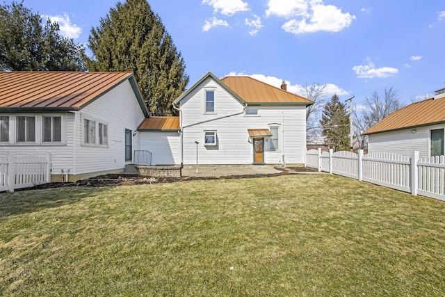 rear view of property with a yard