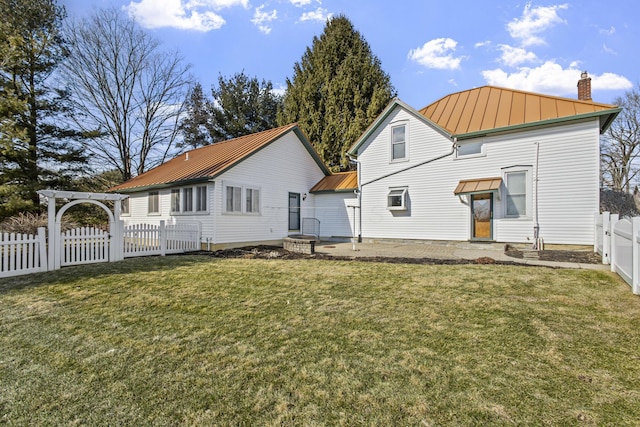 back of property with a lawn, a patio area, and a pergola