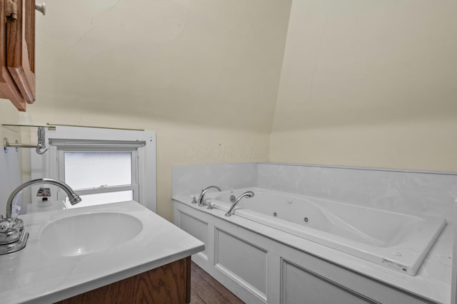 bathroom with vanity and a tub to relax in